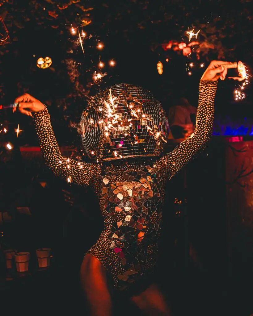 Performer in a mirrored disco ball costume