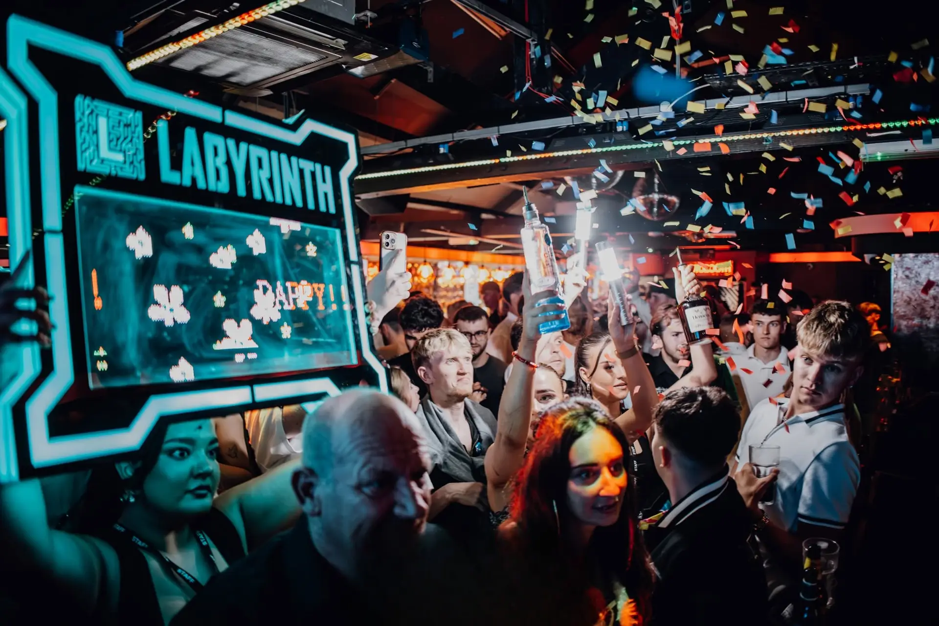 Confetti over a packed room beneath the Labyrinth sign