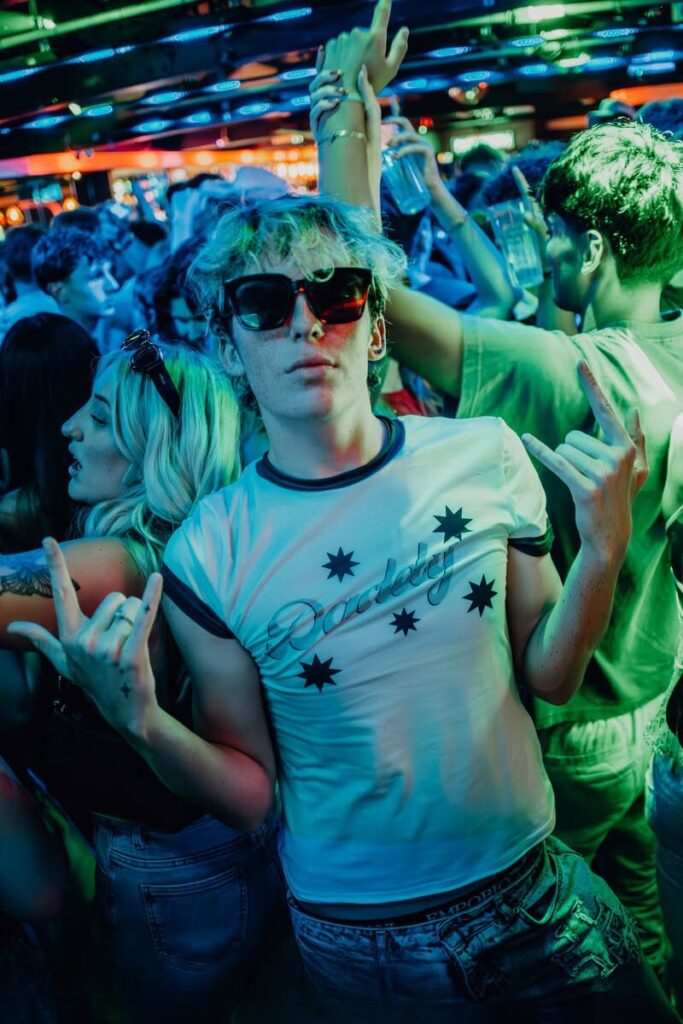 Friends dancing under green lights